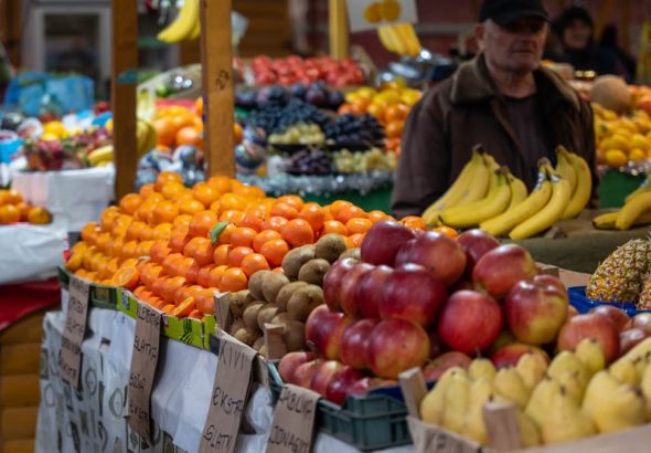 Colorful fruit market stall in Sarajevo, Bosnia, showcasing vibrant fresh produce and lively atmosphere.