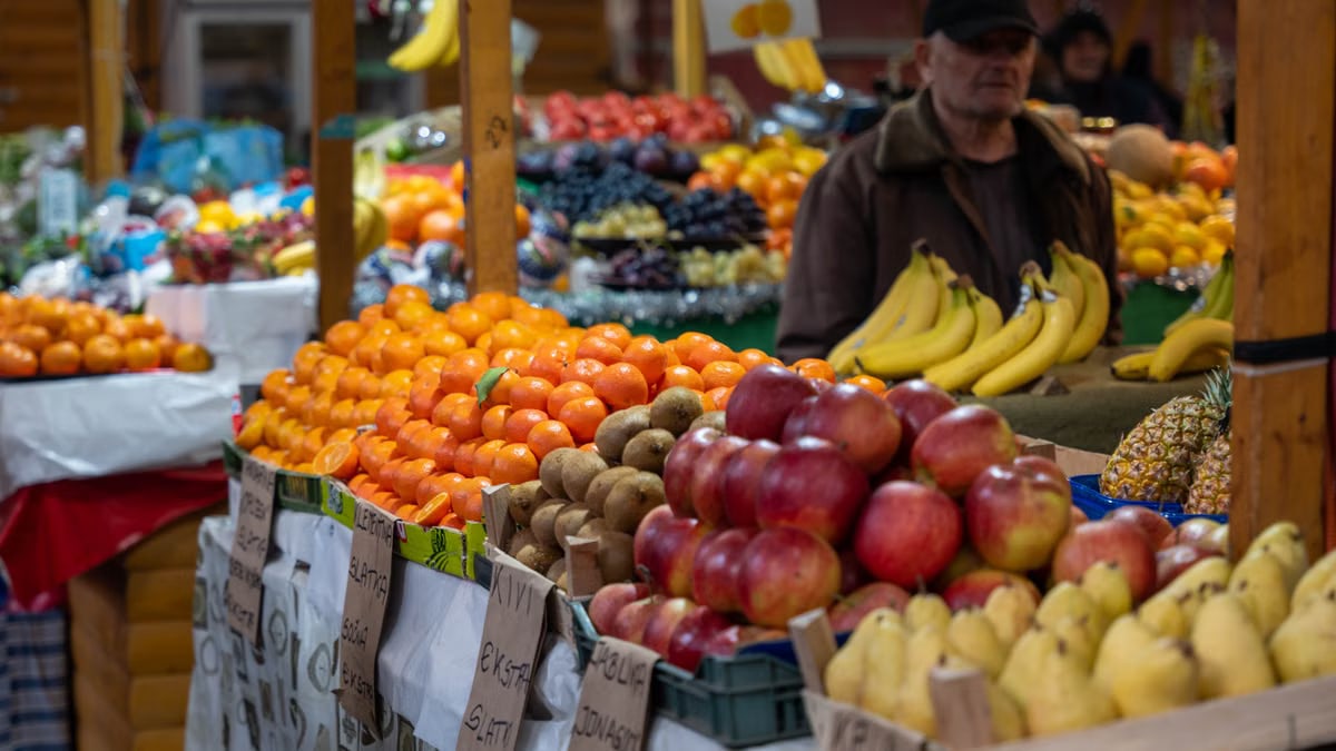 Colorful fruit market stall in Sarajevo, Bosnia, showcasing vibrant fresh produce and lively atmosphere.